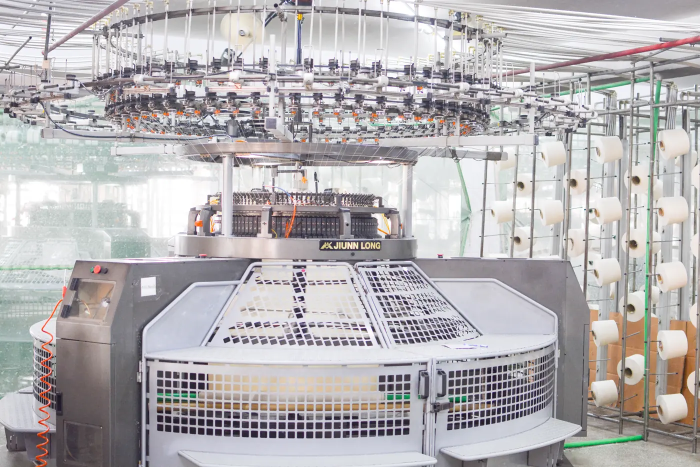 Knitting machines producing fabric